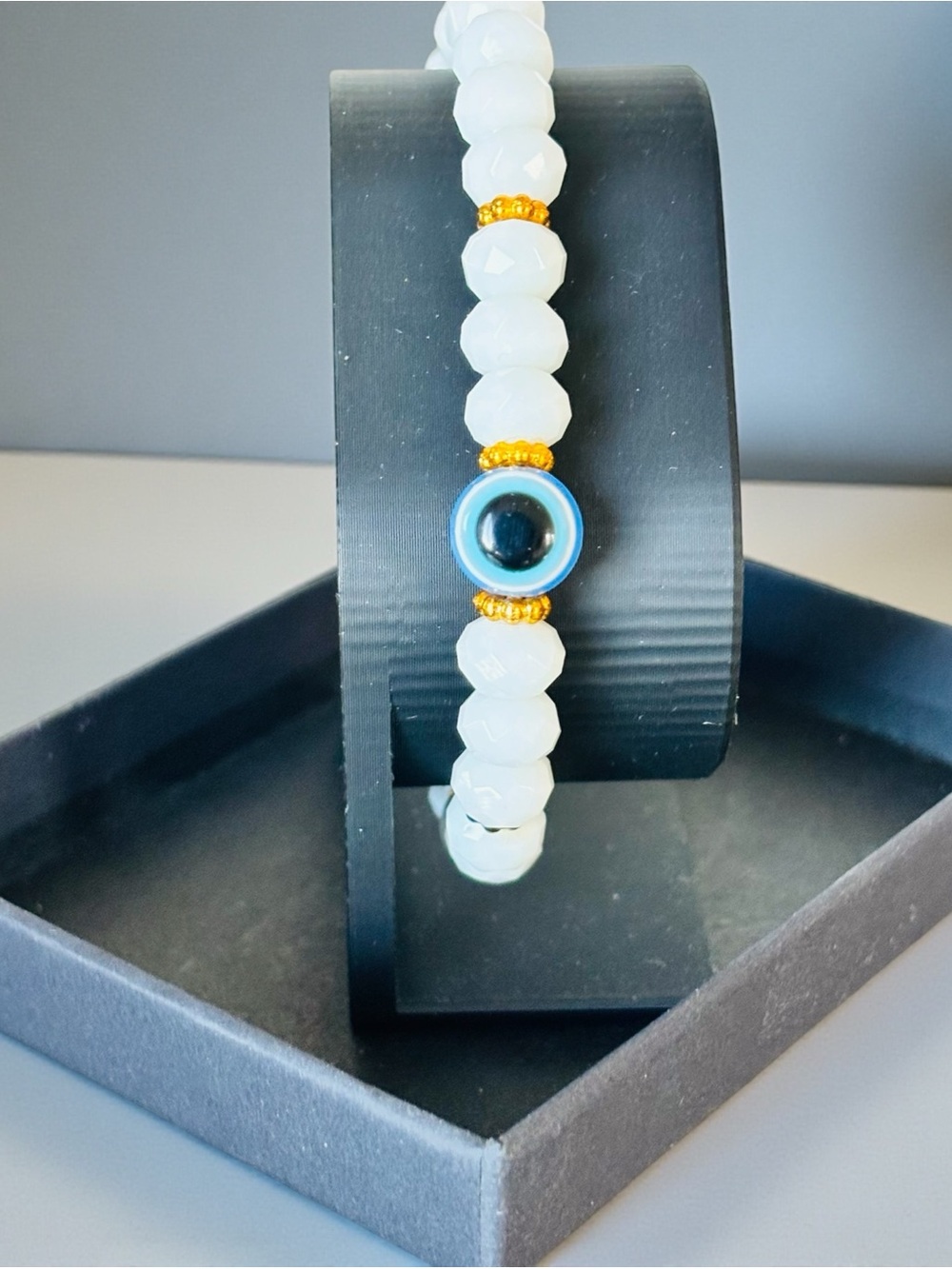 Claire's White Beaded Bracelet with Blue Evil Eye and Gold Accents